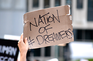 hand holding a nation of dreamers sign